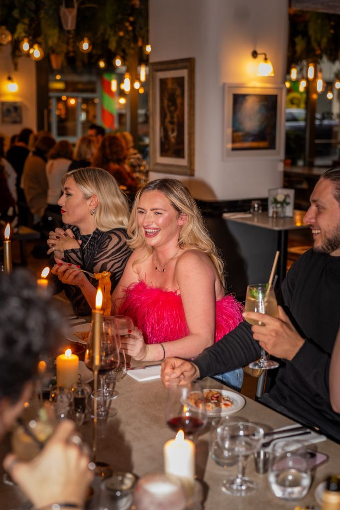 Guests raise their glasses in a toast during a lively private party at Pizza on the Park. The elegant lighting and festive setup create the perfect scene for an office party or birthday celebration at this sought-after venue in Bristol.