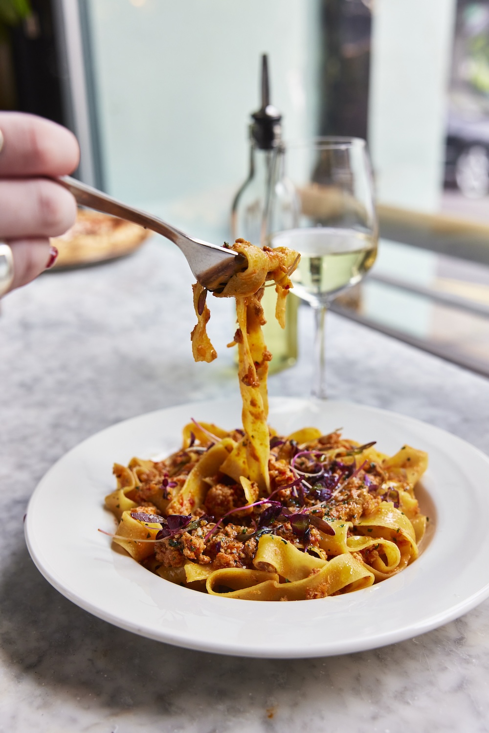 Handmade tagliatelle pasta in a rich Italian meat ragu sauce served at Pizza on the Park, an Italian restaurant offering the best pasta and pizza in Bristol. Captured by David Loftus, this image showcases the authentic Italian dining experience Pizza on the Park provides in Clifton.