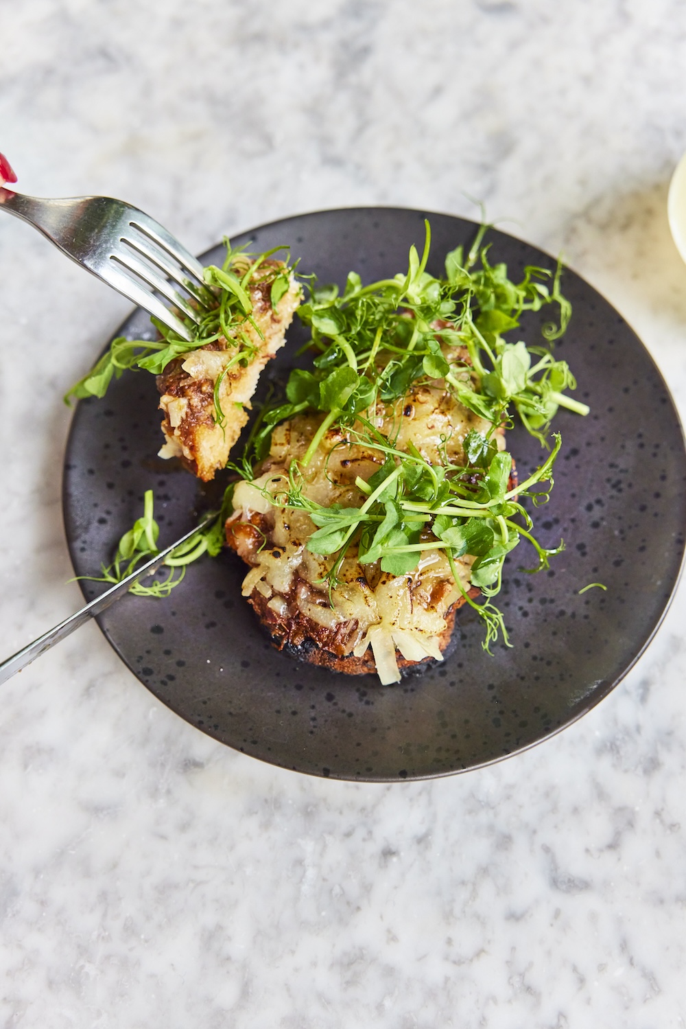 Crispy Italian bread topped with rich slow cooked ox cheek, melted cheese and greens, served as an appetizer at Pizza on the Park, the Italian restaurant in Clifton, Bristol, known for the best pizza and Italian starters. Photographed by David Loftus, this dish adds a rustic Italian charm to the dining experience.